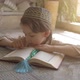 Adorable muslim child in prayer hat and arabic clothes with rosary beads reading holy Koran book  - VideoHive Item for Sale