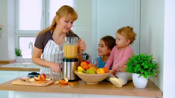 The Family Prepares Smoothies at Home