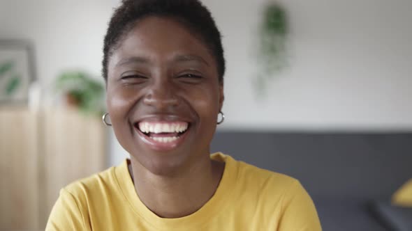 Young Happy African American Woman Smiling at Camera From Home