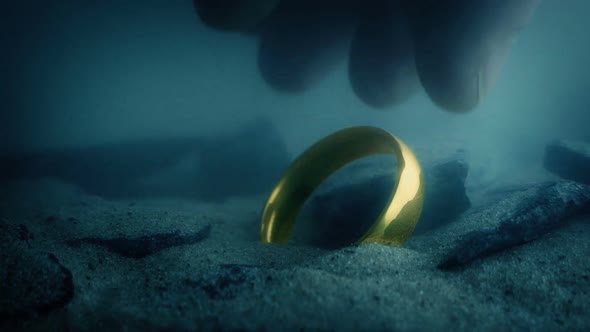 Man Picks Up Gold Ring Underwater