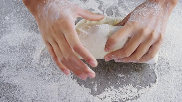 Woman kneading a dough