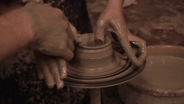 man and girl are engaged in pottery