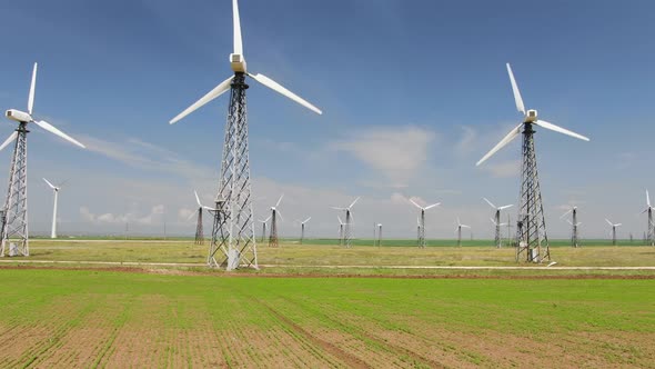 Row of Towers with Wind Turbines in Blue Sky Background