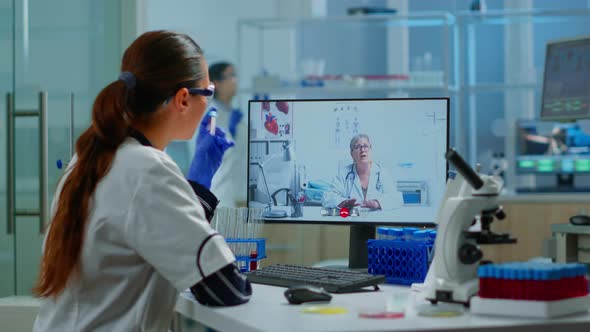 Scientist Listening Professional Doctor on Video Call