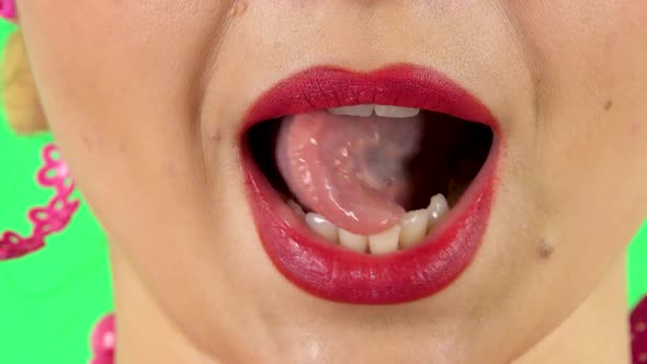 Young Woman with Red Lips Grimacing with Showing Tongue. Close Up