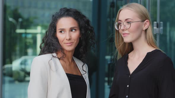 Smiling Multiracial Millennial Female Employees Talk Chat During Break in Office Young Multiethnic