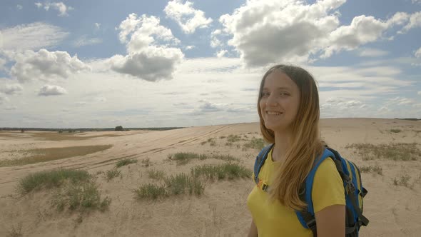 Young Female Hiker Walking in Dunes. Slow Motion alt
