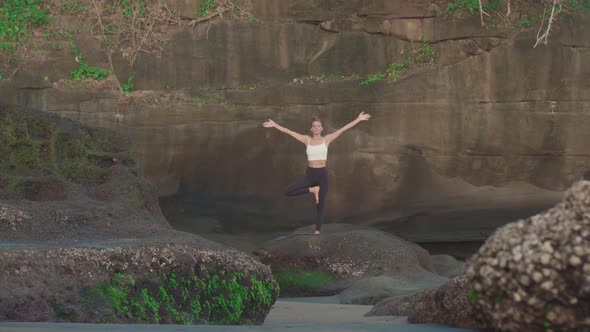 Woman Meditating by Stone Wall