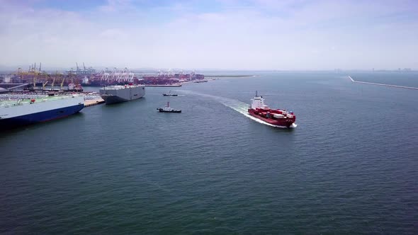 Aerial view of logistics concept cargo ship sailing out to the open sea leaving Laem Chabang dockyar