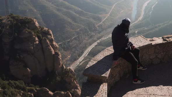 The guy on the observation deck looks at a beautiful view of the mountains