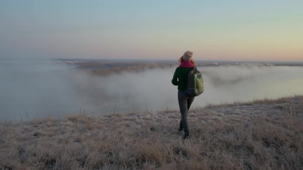 Woman Tourist Walks Into the Fog and Enjoys Nature.