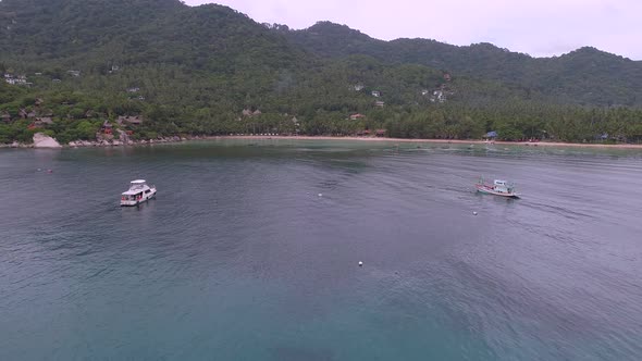 Flying to Tropical Beach near Boats