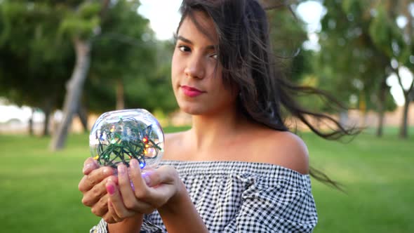 A beautiful and magical gypsy in a forest with an enchanted crystal ball SLOW MOTION.