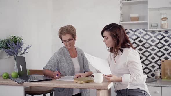 Two Woman at Home Checking Paper Blanks