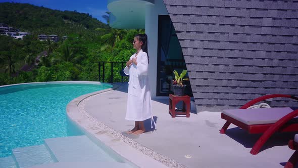 Beautiful Girl In Swimming Suit In Luxurious Villa Walking Into Infinity Pool