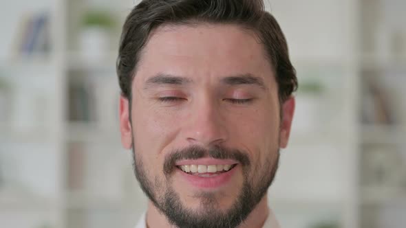 Close Up of Happy Young Man Looking at the Camera