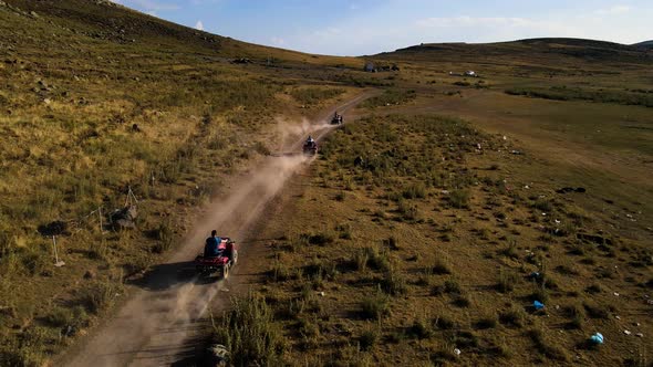 Aerial View From Behind ATVs by Lake and Mountain