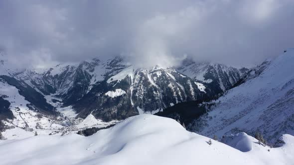 Flight Over Snowcapped Mountains in the Swiss Alps on a Winter's Day