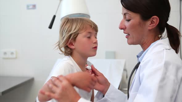 Doctor taking temperature of a child