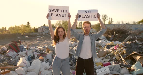 Ecology Activists Holding Signs Agains Pollution at Trash Pill