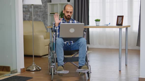 Businessman in Wheelchair Waving