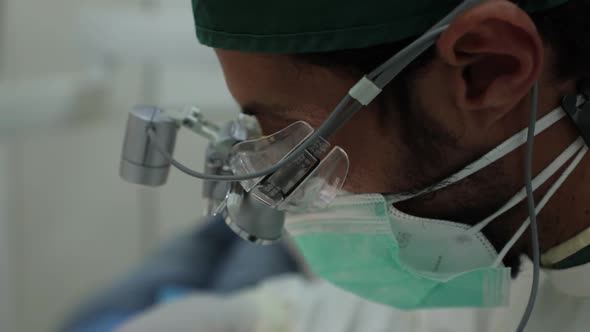 Male dentist in medical mask and glasses in clinic