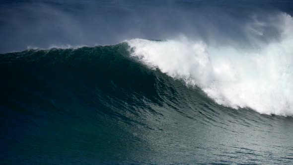 Mighty Ocean Wave Rolling Slowly and Crashing Against the Coast, Producing Much Splashes with White