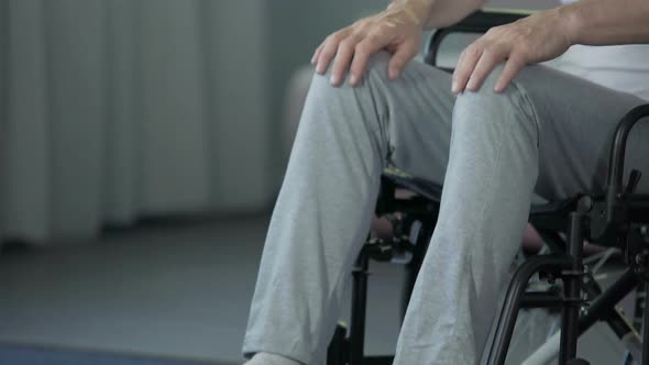 Old Male in Wheelchair Purposefully Moving Forward, Hoping for Quick Recovery
