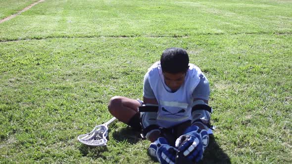 A lacrosse player stretching and warming up.