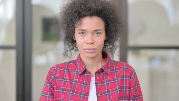 Portrait of African Woman Putting Finger on Lips Silence