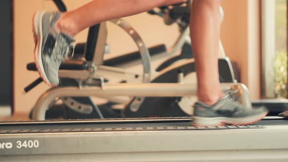 Man Legs Treadmill Running In Home. Cardio Run Workout. Sportsman Jogging Treadmill Running.