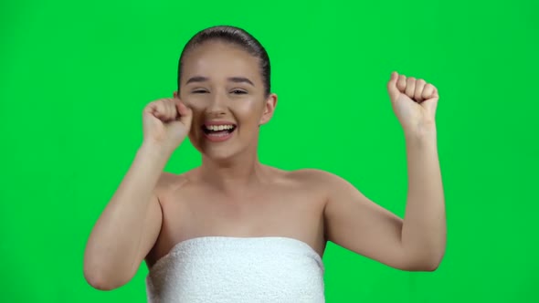 Girl in Towel Celebrating Her Triumph with Victory Dances on Green Screen. Slow Motion