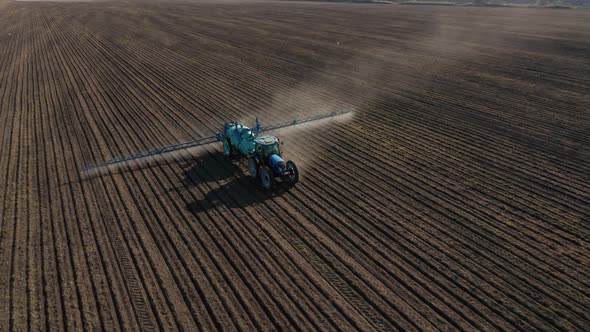 Aerial view of a tractor that irrigates agricultural field