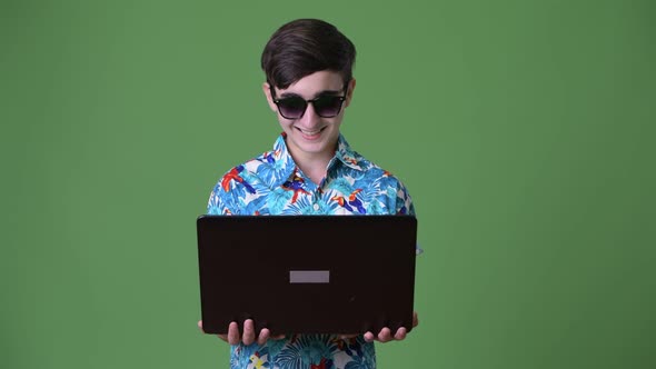 Young Handsome Iranian Teenage Boy Ready for Vacation Against Green Background