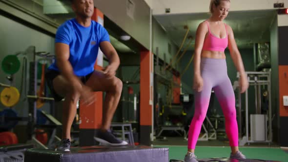 Man and woman exercising in a gym