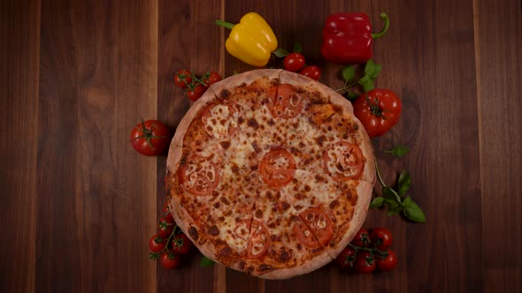 A Whole Rotating Pizza with Tomato and Cheese