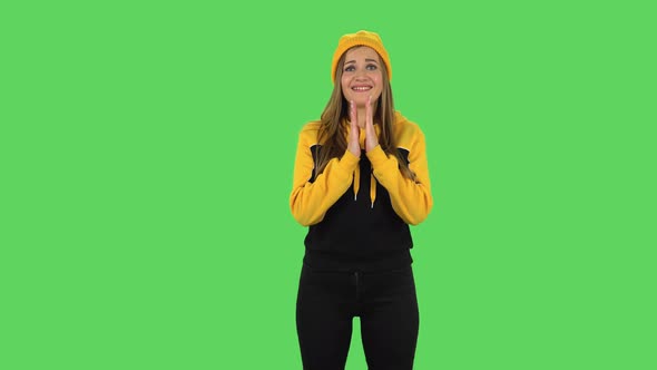 Modern Girl in Yellow Hat Is Waiting in Anticipation with Pleasure. Green Screen