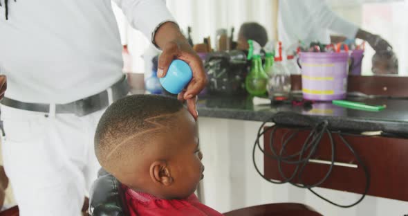 African man making finishes at African boy hair