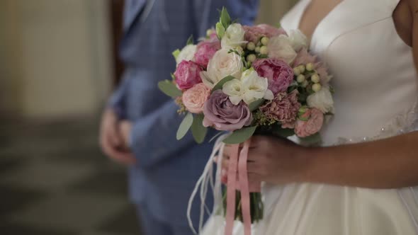 Wedding Bouquet in the Hands of the Bride