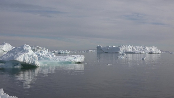 Arctic sailing among glaciers and floating ice blocks, in frozen sea and breathtaking landscape