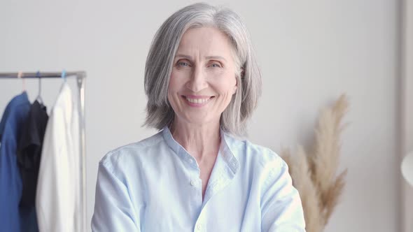 Cheerful Older Woman Fashion Designer Laughing at Workplace Portrait