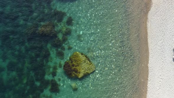 Aerial View on Calm Azure Sea and Volcanic Rocky Shores