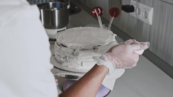 Woman Chef Making a Cake  Applying Cream on the Fresh Cake From Pastry Bag