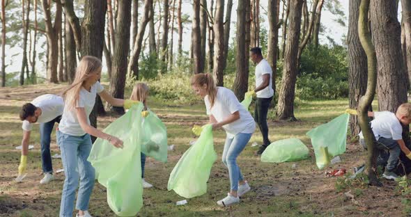 Group of People of Nature in white t-shirts Cleaning the Garbage in Public Park