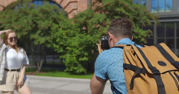 Couple of Tourists Taking Photos with Photo Camera on Historical Place in City