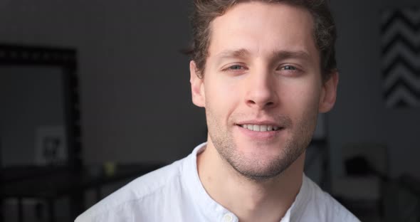 Portrait of Young Confident Man Looking at Camera Smiling