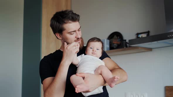 Bearded Father Having Fun with Little Cute Infant on Hands
