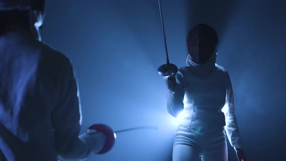 View From Behind on Two Athletes Fencers Competing in Tournament