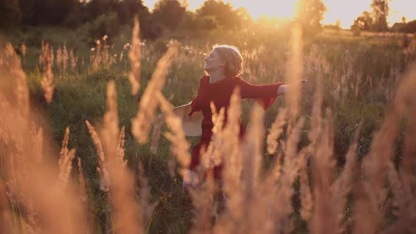 Portrait of Positive Smiling Woman Looking Into Camera at Sunset