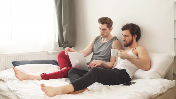 European Gay Lgbtq Men Couple Using Computer Laptop at Home.